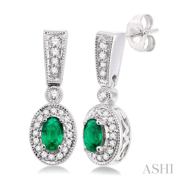 Women’s statement crystal earrings-5x3mm Oval Cut Emerald and 1/3 Ctw Round Cut Diamond Earrings in 14K White Gold