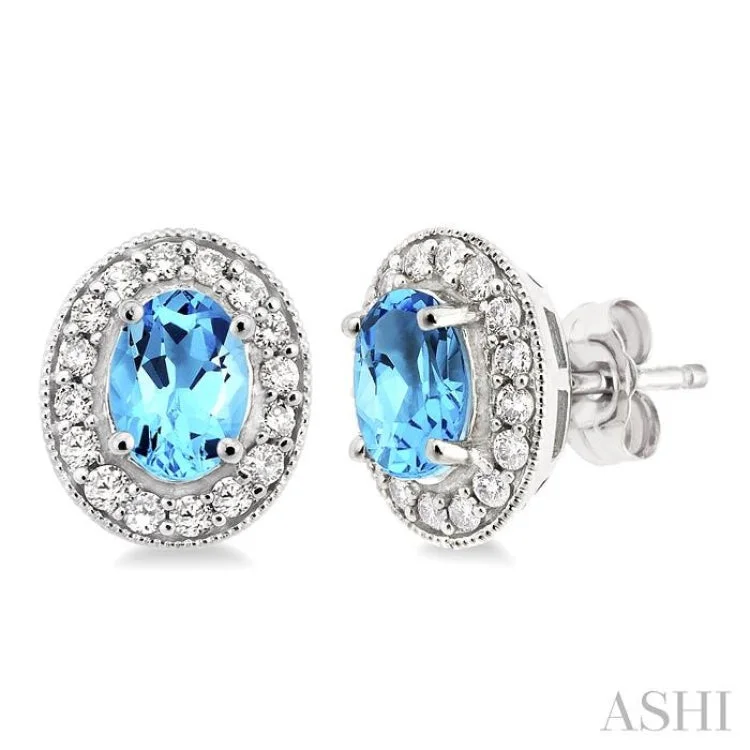 Women’s colorful gemstone earrings-7x5mm Oval Cut Blue Topaz and 3/8 Ctw Round Cut Diamond Earrings in 14K White Gold