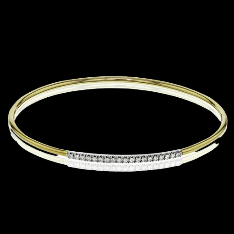 Women’s infinity bangles-This lovely 18k yellow gold bangle contains .13 ctw of white diamonds in a simple line. This bangle is perfect for stacking, or making a delicate statement all on its own.