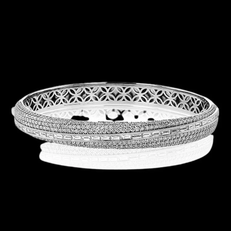 Women’s luxury bracelets-This elegant 18K white gold asymmetric bangle features multi rows of pave round diamonds 2.37 ctw., and a row of horizontal baguette diamonds 1.48 ctw.