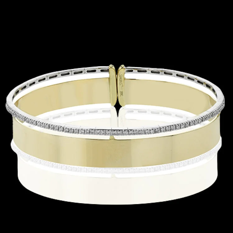 Women’s gold bangles-Make a statement with this wide bangle in yellow gold with a brushed finish and accented by a row of white diamonds .40 ctw.