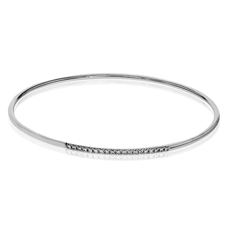 Women’s gemstone charm bracelets-This lovely 18k white gold bangle contains .13 ctw of white diamonds in a simple line. This bangle is perfect for stacking, or making a delicate statement all on its own.