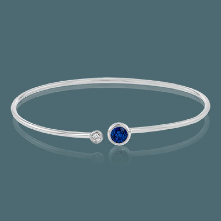 Women’s matching bangles-This understated white gold bangle features a subtle .08 ctw white diamond accent opposite a stunning .71 ctw sapphire. Perfect for stacking.