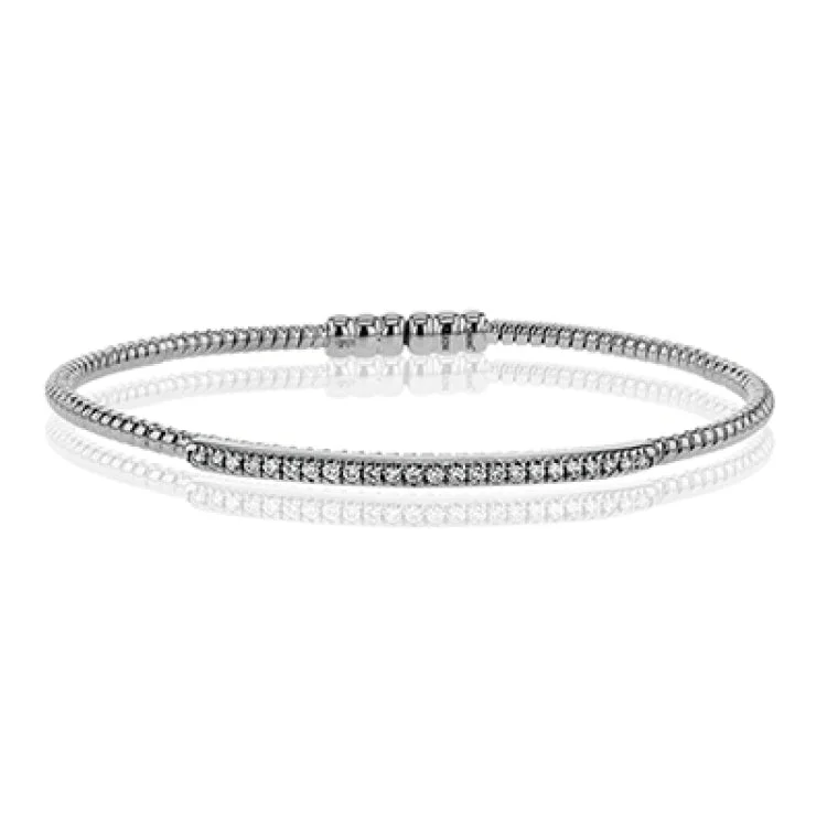 Women’s chic bracelets-This 18k white gold bangle is incredibly easy to wear, while providing a complete dose of style with .24 ctw of white diamonds. Perfect for stacking.