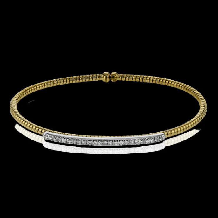 Women’s modern bangles-This 18k 2t white and yellow gold bangle is incredibly easy to wear, while providing a complete dose of style with .24 ctw of white diamonds. Perfect for stacking.