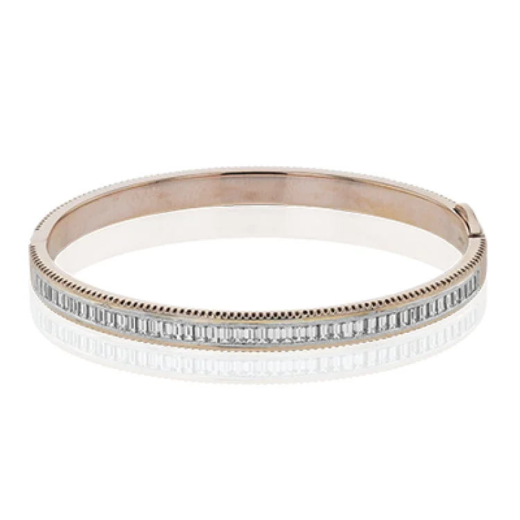 Women’s tennis bangles-A striking 18K bangle in two-tone gold with a row of baguette diamonds 2.0 ctw. set in white gold, with a delicate ribbed edge