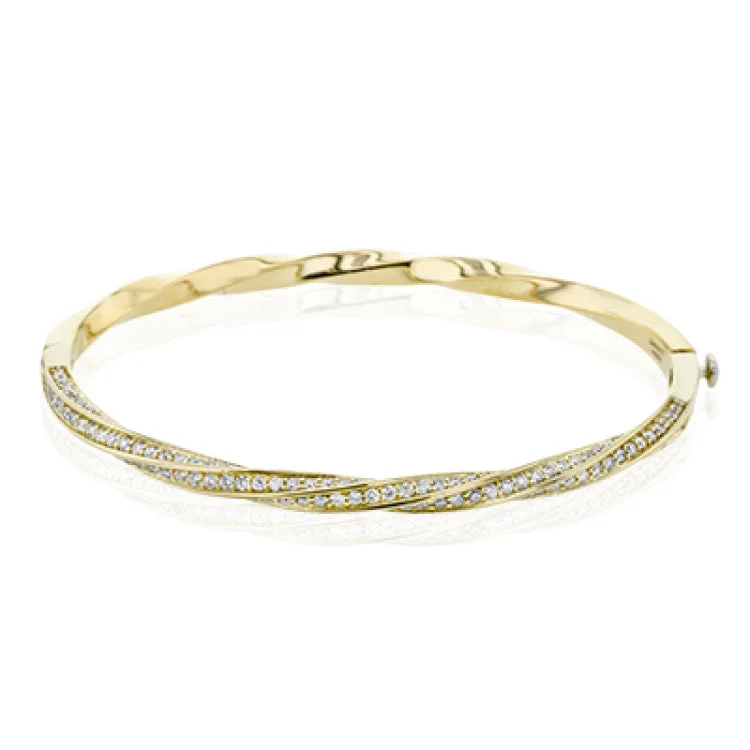 Women’s simple silver bracelets-This modern yellow gold bangle has a distinctive twisting design set with 1.66 ctw of white diamonds.