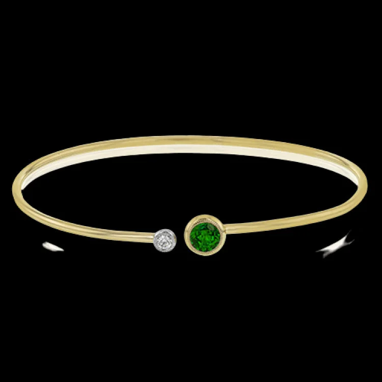 Women’s beaded bracelets-This understated yellow gold bangle features a subtle .08 ctw white diamond accent opposite a stunning .65 ctw emerald. Perfect for stacking.