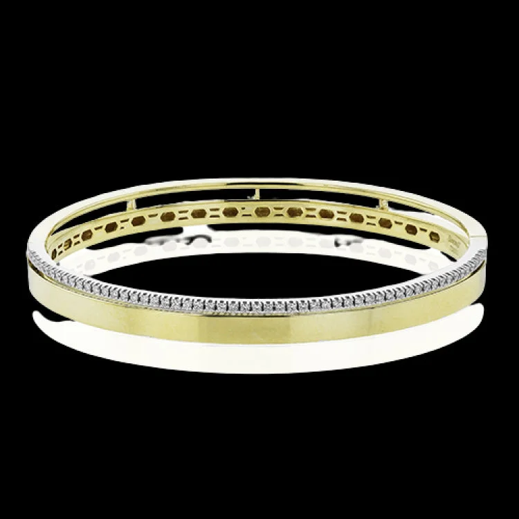 Women’s boho bracelets-This stunning yellow gold bangle has a matte finish and is accented by a row of white diamonds 0.32 ctw., along its edge.