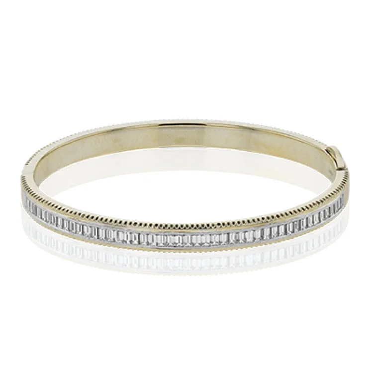 Women’s pearl bracelets-A striking 18K bangle in two-tone gold with a row of baguette diamonds 2.0 ctw. set in white gold, with a delicate ribbed edge