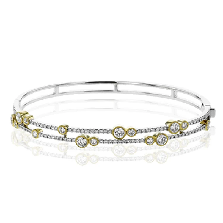 Women’s gold-plated bangles-This whimsical bangle in 18K white gold features 1.80 ctw of bezel set diamonds, that appear to be suspended on a wire