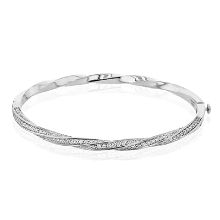 Women’s designer bangles-This modern white gold bangle has a distinctive twisting design set with 1.68 ctw of white diamonds.