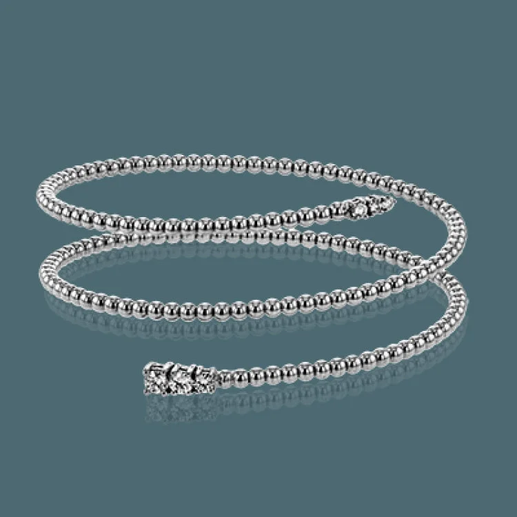 Women’s classic bangle bracelets-This spiral bangle look great stacked but also makes the perfect statement on its own. It contains a total of .54 ctw of white diamonds.