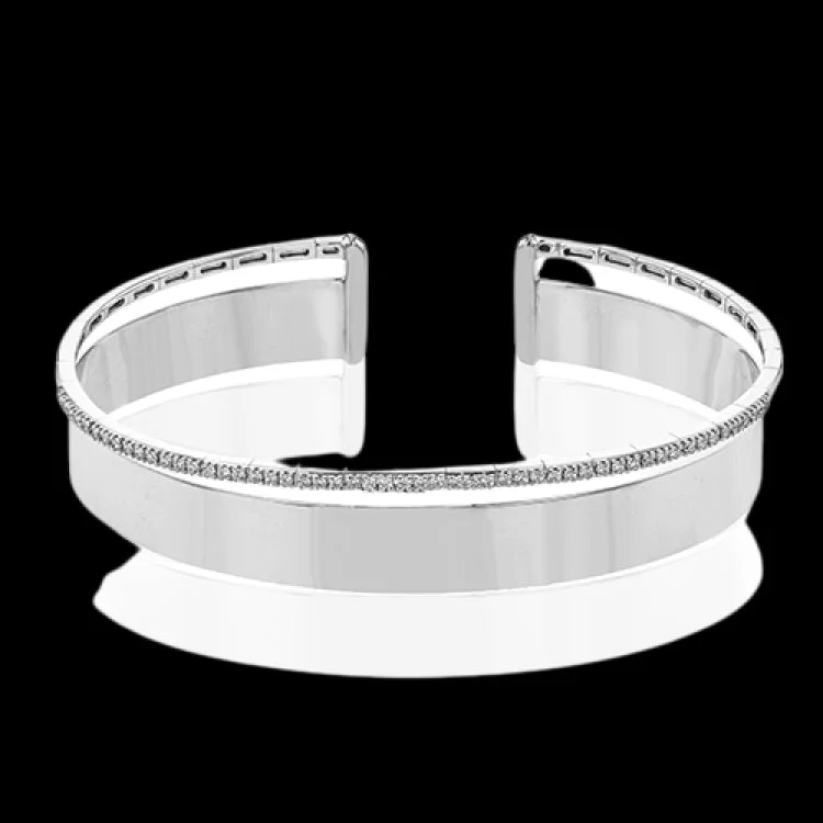 Women’s simple silver bracelets-Make a statement with this wide bangle in yellow gold with a brushed finish and accented by a row of white diamonds .40 ctw.