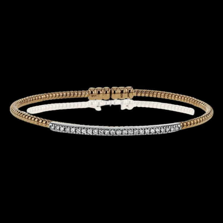 Women’s engraved bangles-This 18k white and rose gold bangle is incredibly easy to wear, while providing a complete dose of style with .24 ctw of white diamonds. Perfect for stacking.