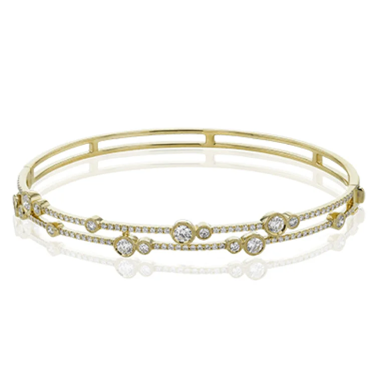 Women’s high-end bracelets-This whimsical bangle in 18K white gold features 1.80 ctw of bezel set diamonds, that appear to be suspended on a wire