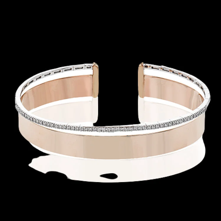 Women’s tennis bangles-Make a statement with this wide bangle in yellow gold with a brushed finish and accented by a row of white diamonds .40 ctw.