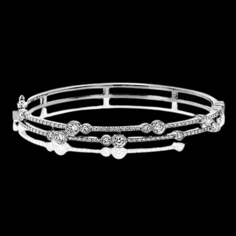 Women’s pearl bangle bracelets-This whimsical bangle in 18K white gold features 1.80 ctw of bezel set diamonds, that appear to be suspended on a wire