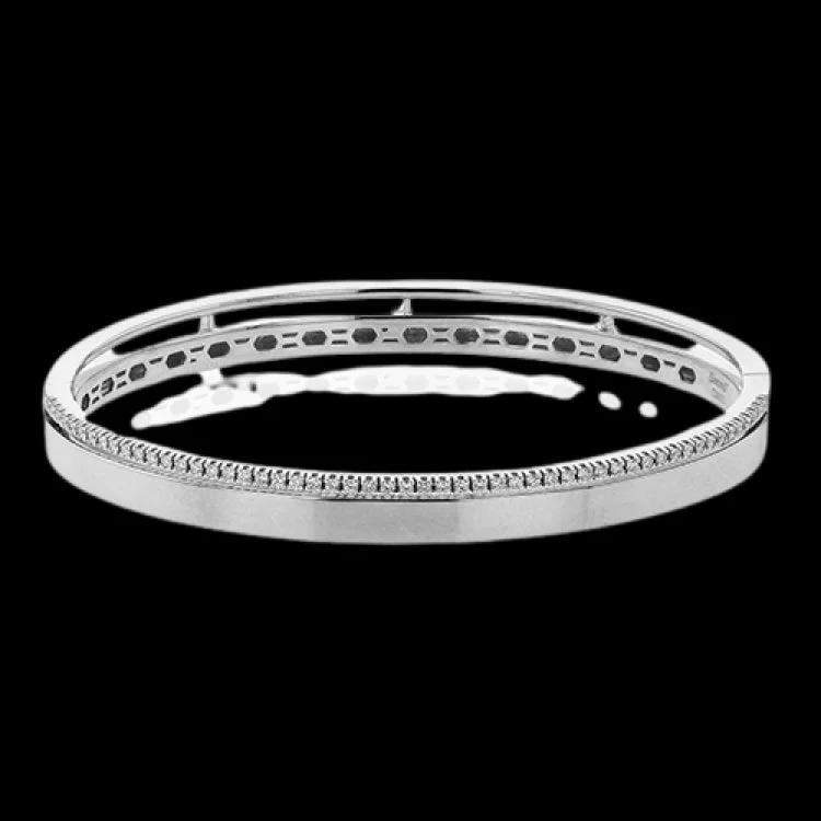 Women’s woven bracelets-This stunning white gold bangle has a matte finish and is accented by a row of white diamonds 0.32 ctw., along its edge.