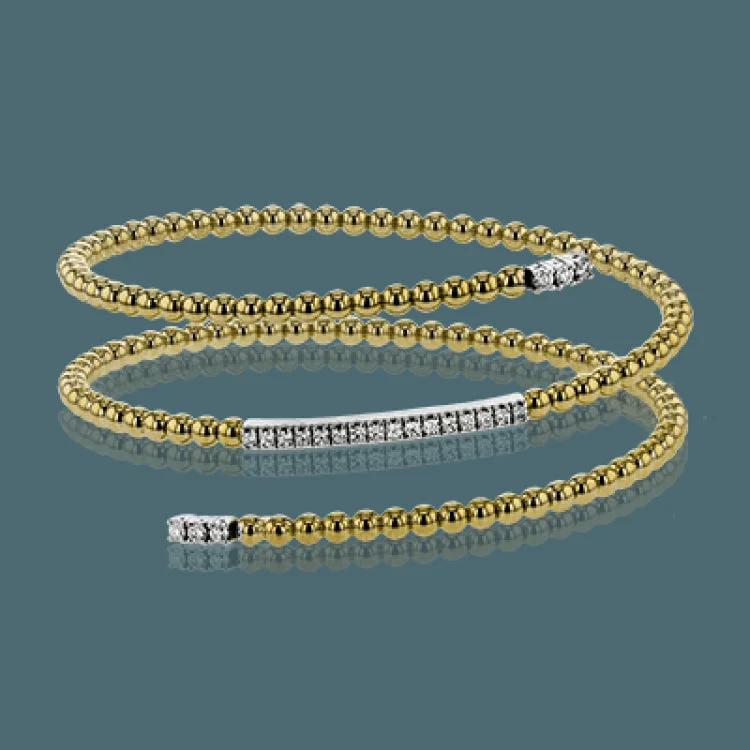 Women’s silver bangles-This delicate two-tone gold bangle hugs the wrist with its understated .42 ctw of white diamond accents. Perfect for stacking.