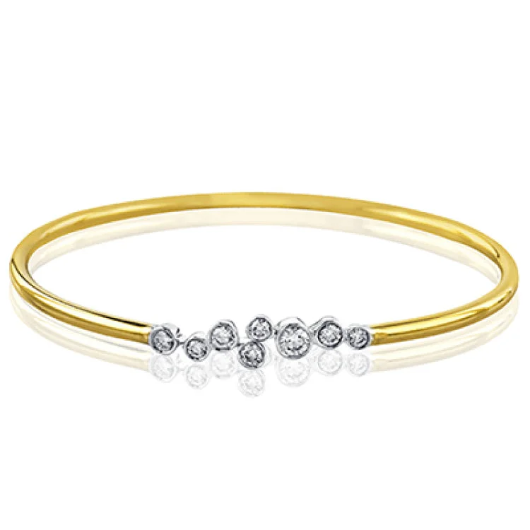 Women’s statement bracelets-The clean, minimalist design of this white and rose gold bangle highlights the .57 ctw of round white diamonds sparkling in its centerpiece. Perfect for stacking.