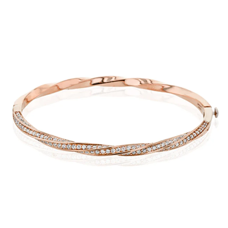 Women’s gold bangles-This modern rose gold bangle has a distinctive twisting design set with 1.68 ctw of white diamonds.